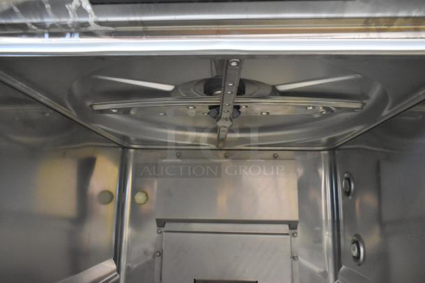 Interior view of a Hobart LXGNR stainless steel commercial glass washer, showcasing spray arm mechanism. New, scratch and dent condition.