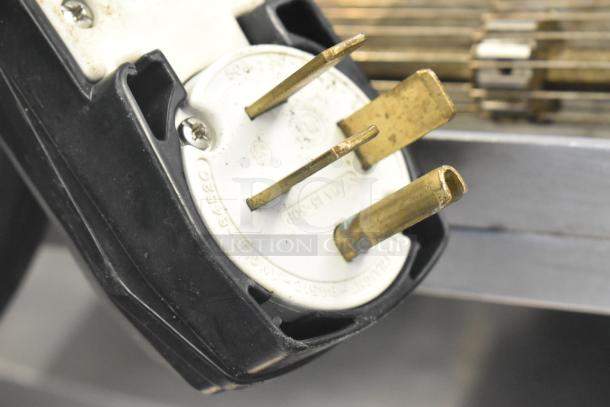 Electric plug of 2018 Turbochef HhC2020 rapid cook conveyor oven, showing a worn metallic 3-phase connector.