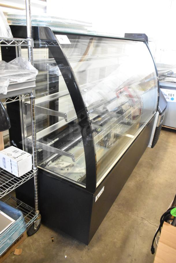 Avantco 193BCTD72B 72" black bakery display case, curved glass, 3 shelves, LED lighting, on casters. Note: broken glass.