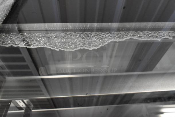 Avantco 193BCTD72B bakery display case with cracked glass, LED lighting, black 72" metal frame, on commercial casters, 115V.