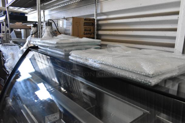 Brand new Avantco 193BCTD72B 72" black metal bakery display case with curved glass and LED lighting. Damaged glass shown.