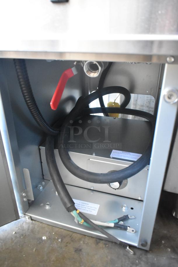 Brand new Avantco 177EF40B stainless steel 40 lb. electric floor fryer, internal view, showing wiring and red handle.