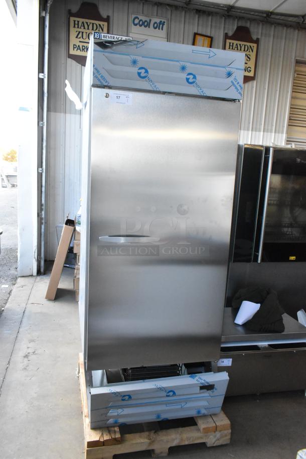 Stainless steel Beverage Air FB27HC-1S single door freezer, new with scratches, on a pallet; poly-coated racks visible.