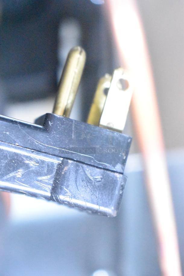 Close-up of the power plug of a Beverage Air FB27HC-1S Reach-In Freezer, 115 volts, 1 phase electric cord.