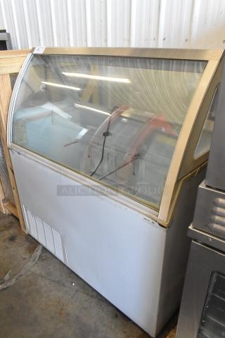 Metal commercial ice cream dipping cabinet, 115 volts, 1 phase, clear curved glass top, minor wear, suitable for display.