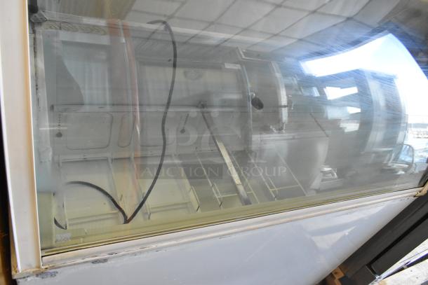 Metal commercial ice cream dipping cabinet, 115 volts, 1 phase, glass top, visible shelving, minor wear, good condition.