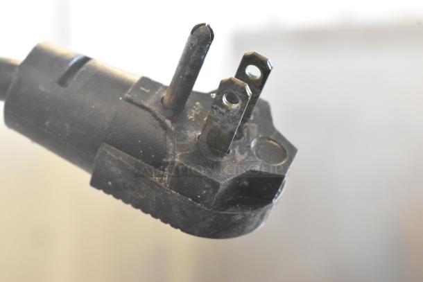 Close-up of a three-prong power plug for a metal commercial ice cream dipping cabinet. 115 volts, 1 phase.