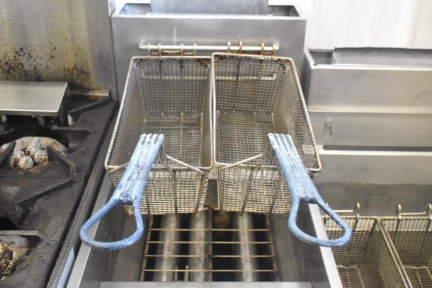 Globe GFF35G commercial stainless steel deep fat fryer with two metal fry baskets, 90,000 BTU, natural gas powered.