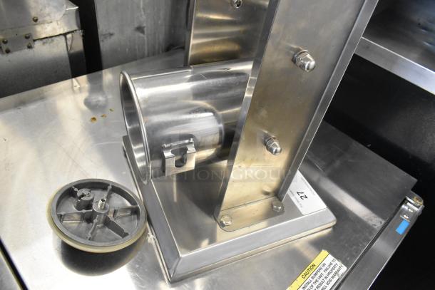 Avantco stainless steel commercial countertop sausage stuffer, visible sturdy construction, minor wear, essential for food service settings.