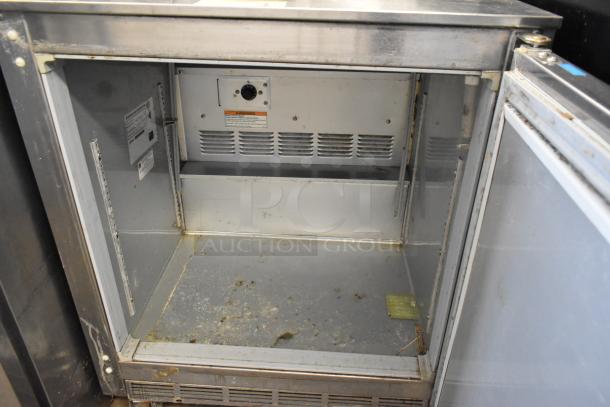 Beverage Air UCF27A-23 stainless steel undercounter freezer with visible wear, single door, 115V, 1 phase, commercial casters.