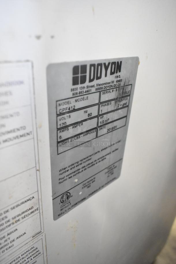 2018 Doyon CPF412 metal bread loaf slicer on commercial casters. Features label detailing model, voltage, and specifications.