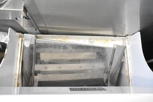 2018 Doyon CPF412 metal bread loaf slicer on casters, showing interior blades. Operates on 115 volts, 1 phase. Visible wear.