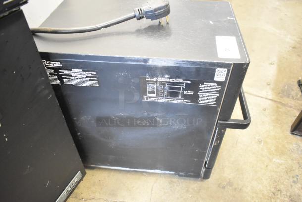 Turbochef metal commercial countertop rapid cook oven, electric-powered, 208/240 volts, 1 phase, with visible labels featuring safety and operating instructions.