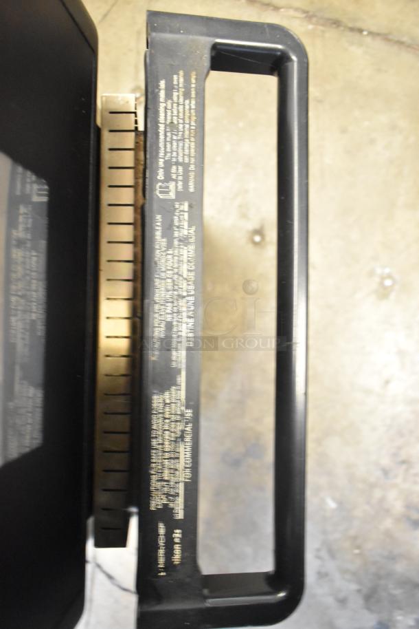 Turbochef metal commercial electric rapid cook oven, 208/240V, 1 phase, visible handle and caution label with usage instructions.