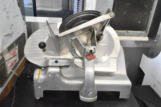 Berkel metal commercial countertop meat slicer, 115 volts, 1 phase, in used condition with visible wear and safety warning label.