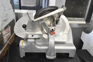 Berkel metal commercial countertop meat slicer, 115 volts, 1 phase, in used condition with visible wear and safety warning label.