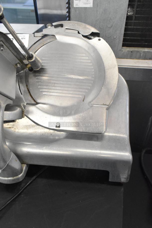 Berkel metal commercial countertop meat slicer, 115 volts, 1 phase. Slight wear, sturdy construction.