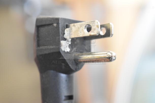 Alt Text: Imbera VR12 metal commercial cooler power plug, 115 volts, 1 phase, black with visible wear and wear marks.