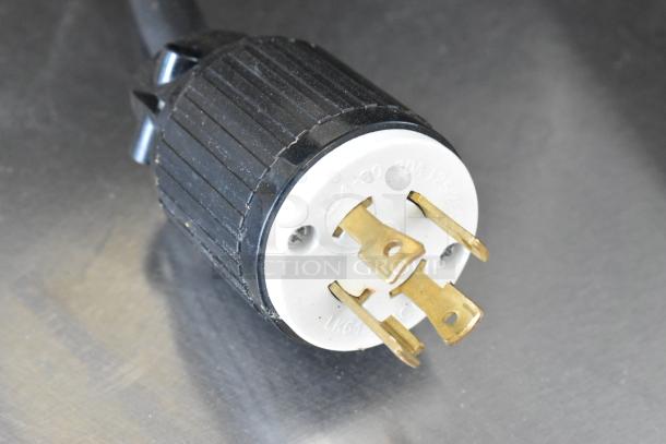 Plug for Curtis TP2T10A3159 stainless steel commercial double coffee machine, 220 volts, 1 phase, showing prongs and markings.