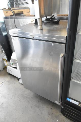 Perlick BN24 stainless steel undercounter cabinet, single door, missing one leg, some surface wear visible.