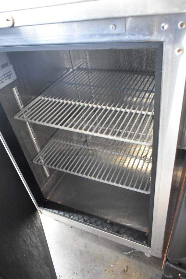 Perlick BN24 stainless steel single door undercounter cabinet, two shelves, missing leg, visible label with model details.