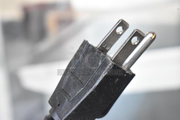 Close-up image of a standard electrical plug associated with the KoolMore CDC-3C-WH countertop display refrigerator.