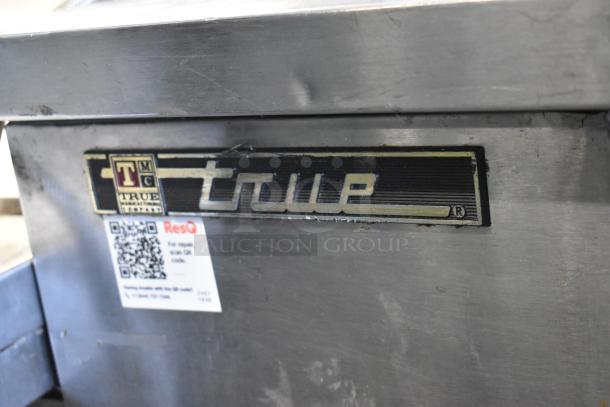 True TBB-4G-S-LD metal commercial cooler, 3 doors, back bar style. Features True logo and ResQ repair label. 115 Volts, 1 Phase.