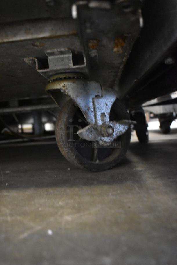 2019 Bison BST-72-30 stainless steel prep table caster with visible rust, showcasing commercial mobility.