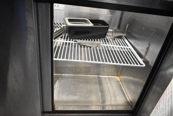 2019 Bison BST-72-30 stainless steel commercial prep table with wire shelf, visible use; suitable for sandwich/salad stations.