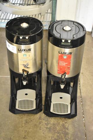 Two Fetco Luxus L3D-15 stainless steel beverage dispensers with drip trays, labeled Veranda and Holiday Blend.