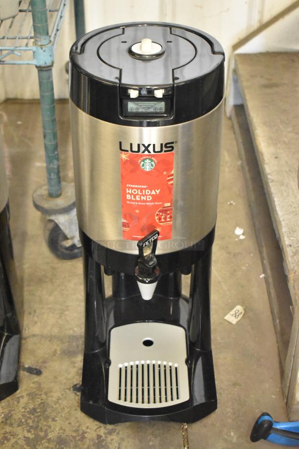 Two Fetco Luxus L3D-15 stainless steel beverage dispensers with drip trays, featuring "Holiday Blend" branding.