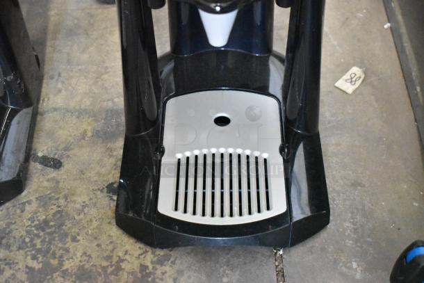 2 Fetco Luxus L3D-15 beverage holders with drip trays, stainless steel, excellent condition, auction includes two units.