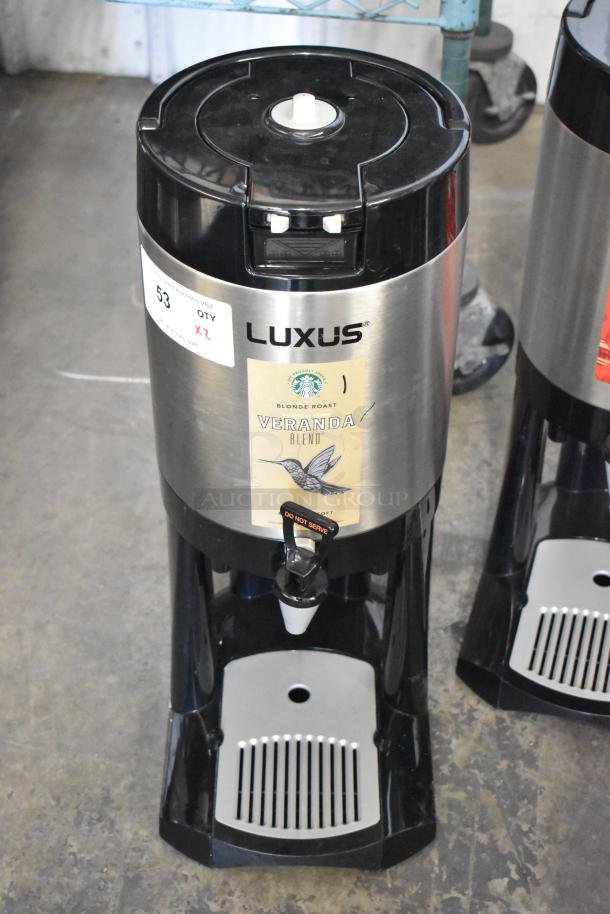 Fetco Luxus L3D-15 stainless steel beverage dispenser with drip tray, Starbucks Veranda Blend label, and auction tags visible.