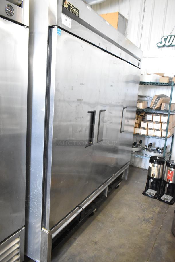 True T-72 stainless steel 3-door commercial reach-in freezer with poly-coated racks, on casters. 115V, 1 phase.