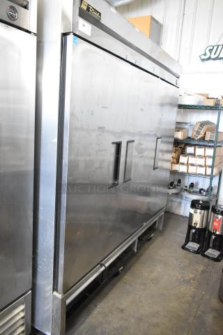 True T-72 stainless steel 3-door commercial reach-in freezer with poly-coated racks, on casters. 115V, 1 phase.