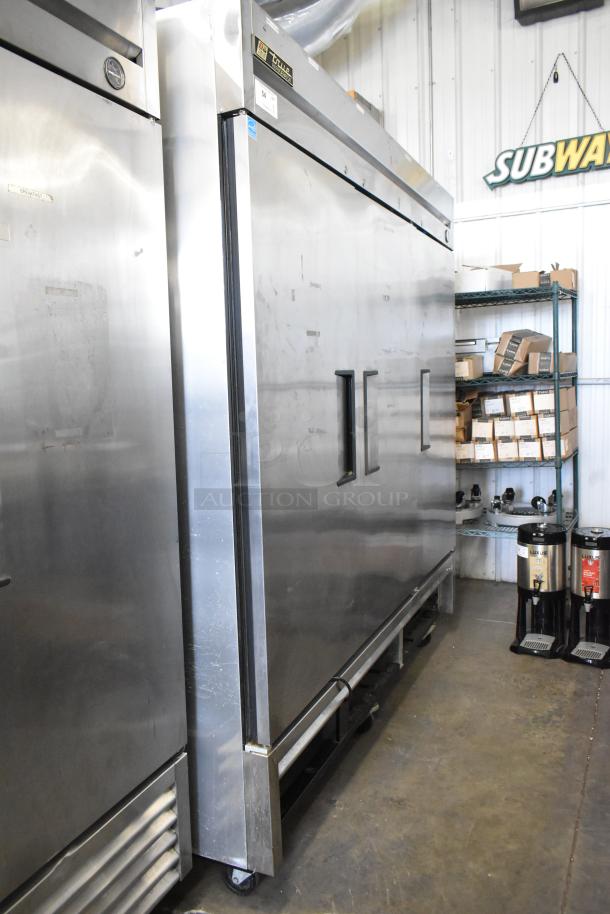 True T-72 stainless steel 3-door commercial reach-in freezer with poly-coated racks, on casters, 115V, 1 phase, visible labels.