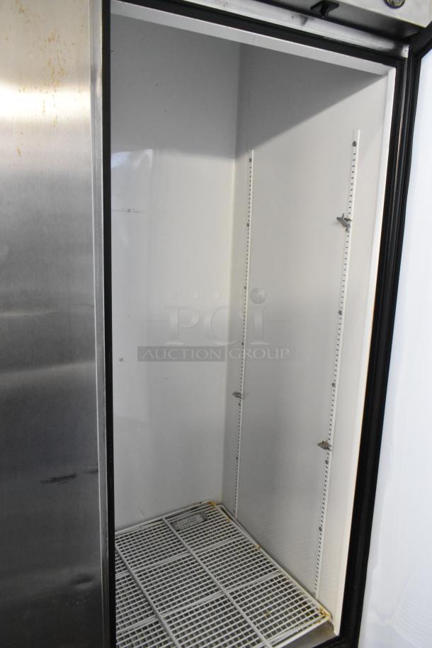 True T-72 stainless steel 3-door reach-in freezer, poly coated racks, commercial casters, 115V, 1 phase, inside view.