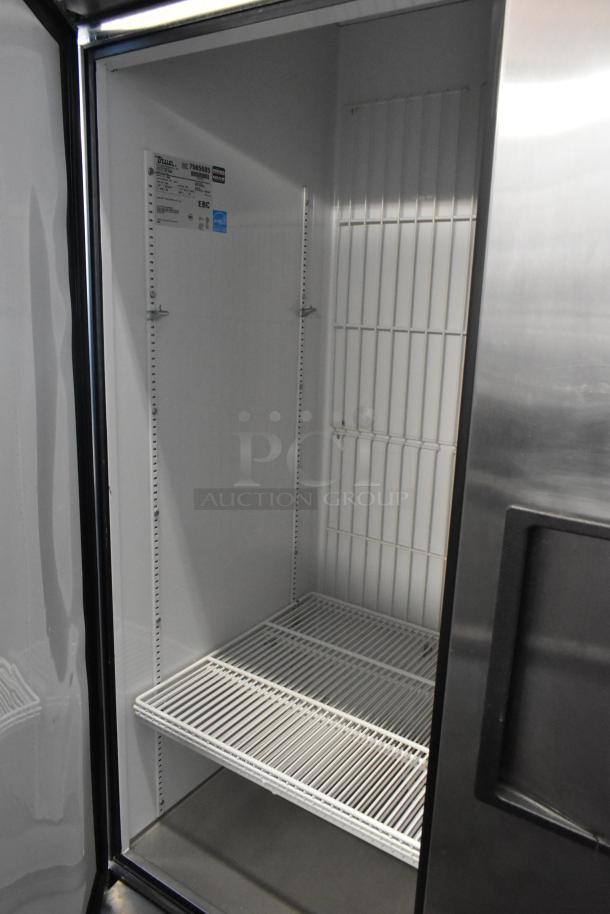 True T-72F stainless steel 3-door reach-in freezer, poly-coated racks, commercial casters, 115V, 1-phase. Model label visible.