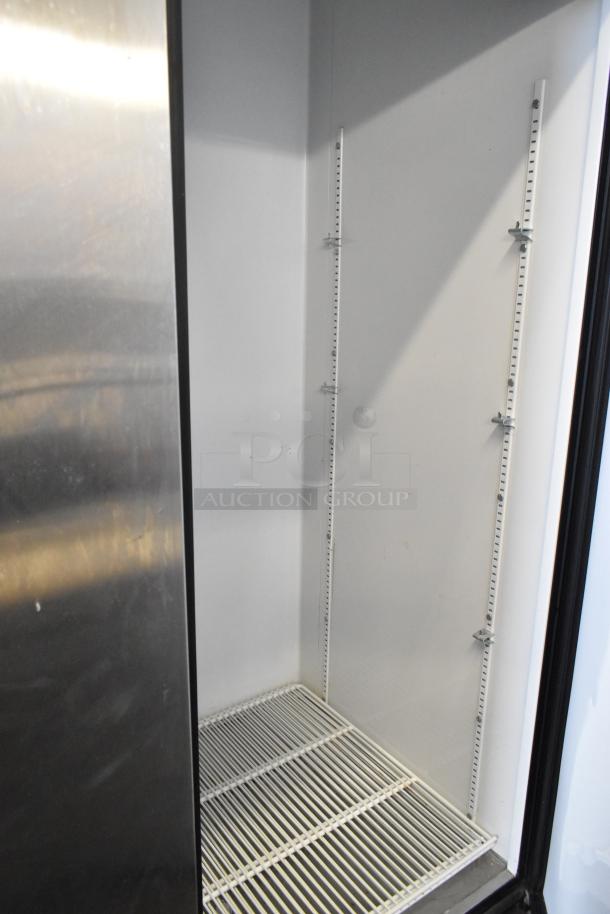 True T-72 stainless steel 3-door cooler interior with poly-coated racks, on casters. Model T-72, 115V, 1 Phase.