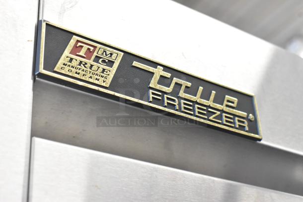True T-72F stainless steel commercial 3-door reach-in freezer, featuring durable design and poly-coated racks, 115V, 1-phase.