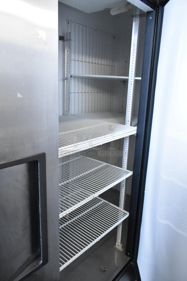 True T-72F stainless steel 3-door commercial freezer with poly-coated racks, on commercial casters. 115V, 1 phase.