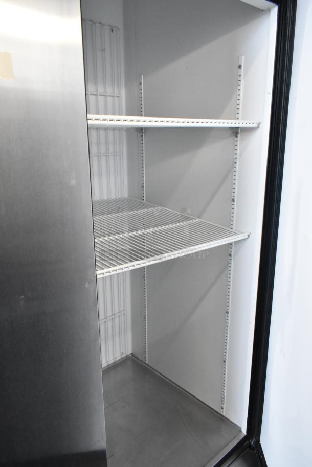 True T-72F stainless steel 3-door commercial reach-in freezer, poly-coated racks, on casters, 115V, 1 phase.