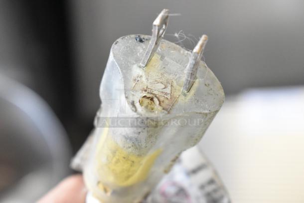 Plug of a BMC Metal Commercial Hamburger Forming Machine, 115 volts, 1 phase; visible wear on the prongs.