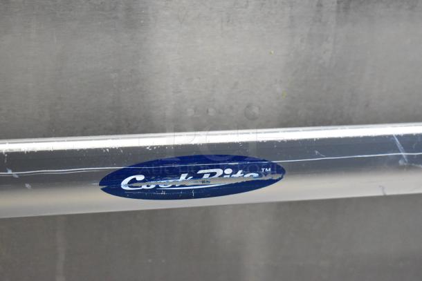 Cookrite Stainless Steel Gas Range with 4 Burners, Griddle, Oven, Over Shelf, and Back Splash on Casters. Signs of use visible.