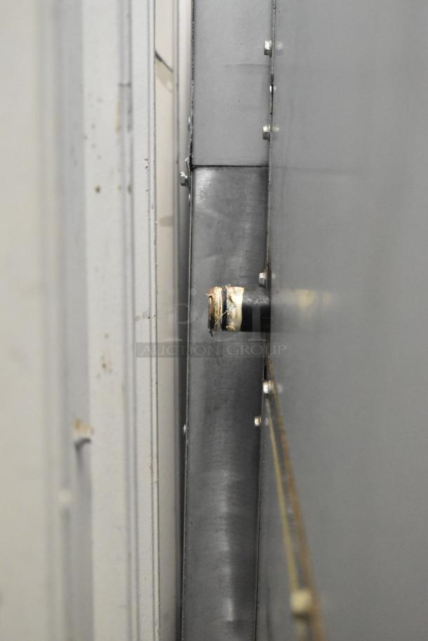 Cookrite stainless steel gas range, 4 burners, flat top griddle, oven, over shelf, back splash, on commercial casters.