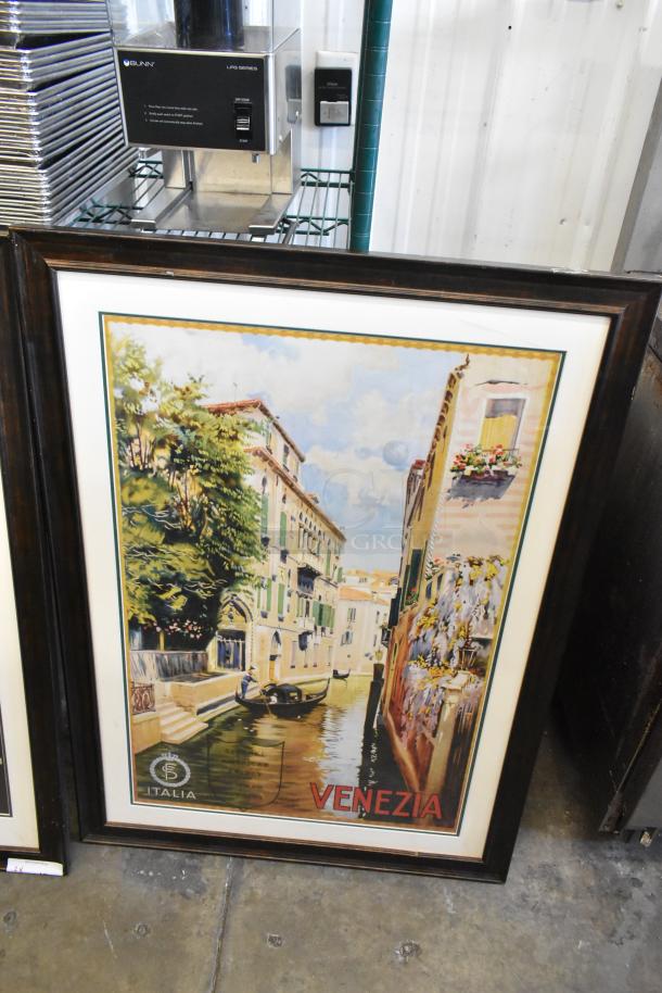 Framed Venezia poster depicting a Venetian canal scene, vibrant colors, wooden frame in good condition, Italy branding visible.