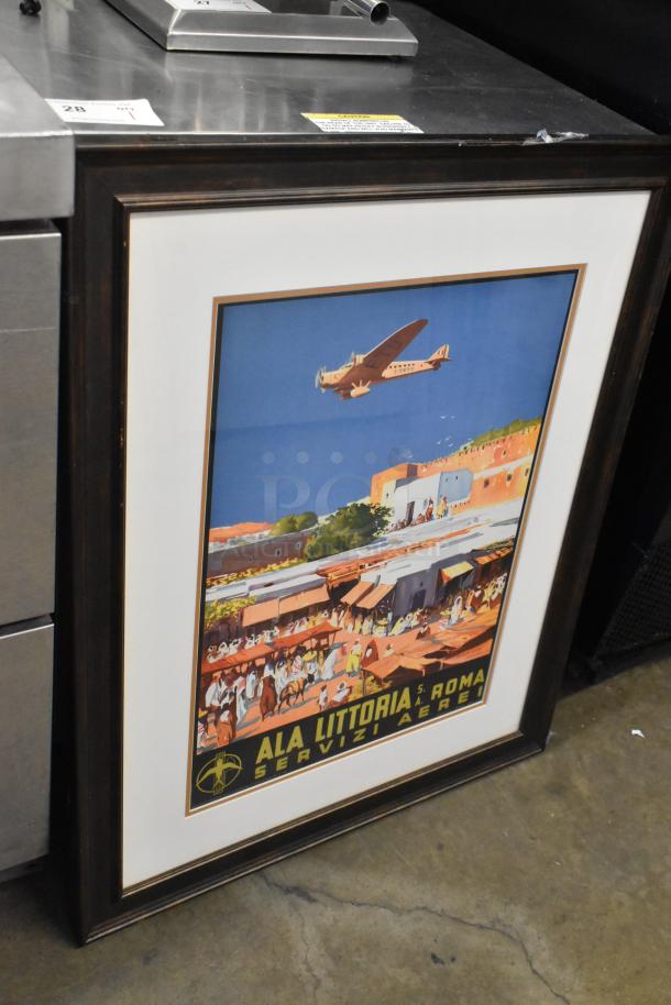 Framed print of an "Ala Littoria" vintage aviation poster. Good condition, wooden frame. Part of a 7-item auction lot.