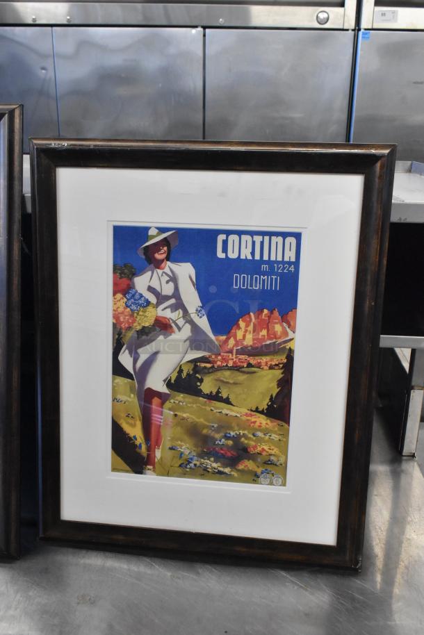 Framed picture of a vintage Cortina Dolomiti poster with a woman in a white outfit. Dark wood frame, in good condition.