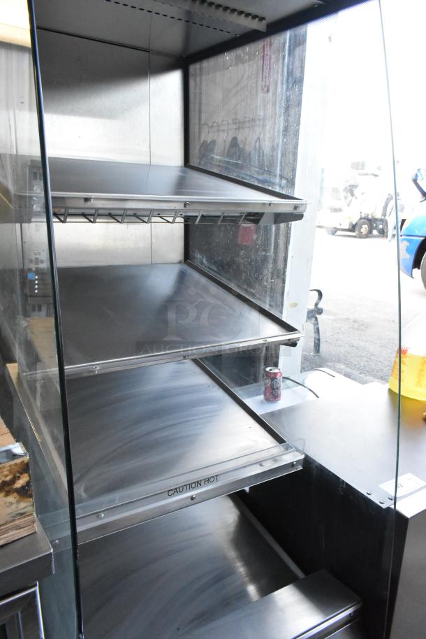 BKI HSS2-4T metal hot merchandiser with multi-shelf design, on commercial casters. Features "Caution Hot" label. 208V, 1 phase.