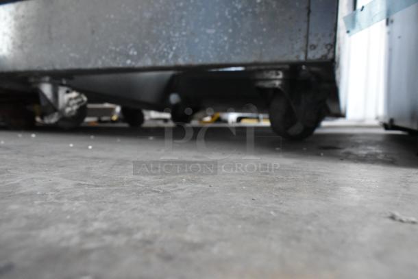 BKI HSS2-4T metal commercial reach-in hot merchandiser with multi-shelf, visible on commercial casters. 208V, 1 phase.